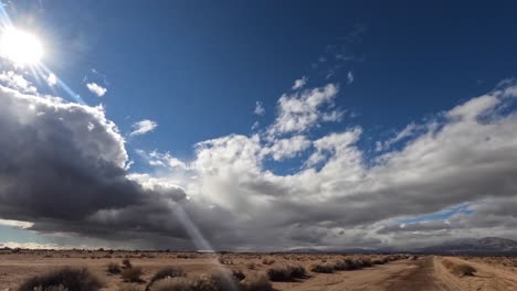 Stormy-rain-clouds-over-the-arid-landscape-of-the-Mojave-Desert-with-mountains-in-the-distance---time-lapse