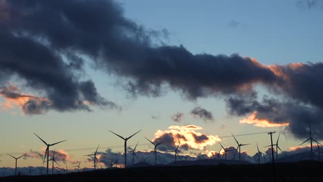 Wind-turbines-in-the-Mojave-Desert-spinning-and-generating-environmentally-clean-energy-at-sunset---wide-angle-time-lapse