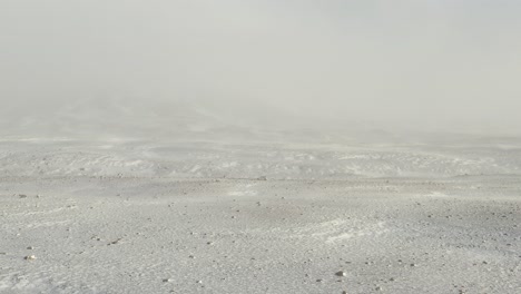 Off-road-vehicle-in-the-middle-of-a-white-snow-landscape-during-a-snow-squall