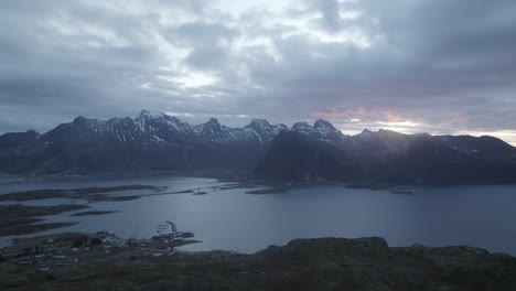 Aerial-view-overlooking-the-Fredvang-bridges,-gloomy-sunrise-in-Lofoten,-Norway---tracking,-drone-shot