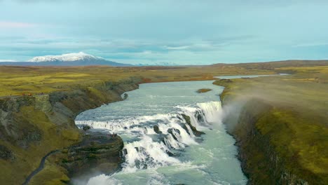 Scenic-landscape-of-a-waterfall-in-Iceland-golden-circle-with-a-mountain-as-background,-panoramic-nature-view