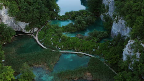 Aerial-View-Of-Wooded-Trails-Along-The-Lakeshores-Of-Plitvice-Lakes-National-Park-In-Central-Croatia