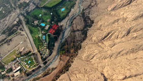 Above-view-of-country-club-in-Peruvian-Lima-Region-at-the-side-of-a-mountain-range