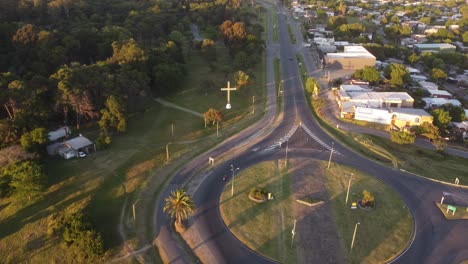 Aerial-tracking-shot-of-Motorcycle-driving-on-road-and-roundabout-during-sunset-Colonia-del-Sacramento,Uruguay