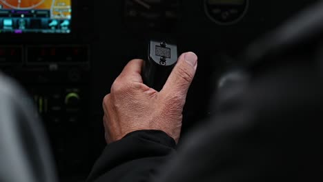 Close-up-of-older-male-pilot-flying-Cessna-182-through-turbulence,-handheld