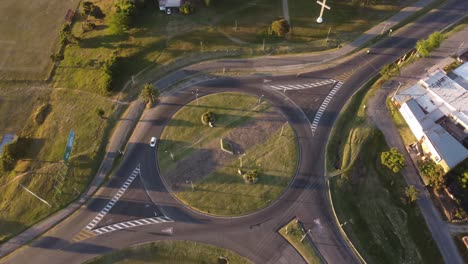 Rotating-aerial-view-of-countryside-roundabout-during-sunset