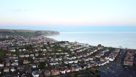 Aerial-panorama-shot-of-a-beautiful-English-coastal-town-at-sunset