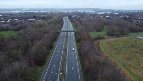 A557-Rainhill-Runcorn-Widnes-expressway-aerial-view-down-British-highway-reversing-shot