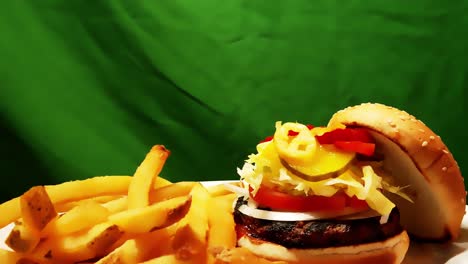 burgers-and-fries-skinless-on-a-plate-with-a-chromakey-green-background-as-a-white-plate-rotating-360-degrees-in-a-the-juicy-combo-of-meat-with-grill-marks-in-Kaiser-bun-with-sesames-and-garnishes-1-2