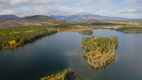 Flyover-above-scenic-British-Columbia-lake-surrounded-by-autumn-foliage
