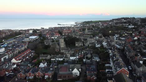 Aerial-shot-of-Swanage-Town-with-the-church-and-pier-in-view,-England