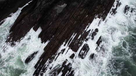 Top-Down-Aerial-View-of-Ocean-Waves-Breaking-on-Rugged-Coast-of-Ireland,-Birds-Eye-Drone-Shot