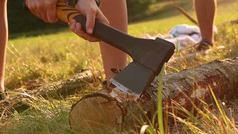 Axe-Cutting-Tree-Timber-On-Ground,-Scout-Survival-Concept,-Close-Up