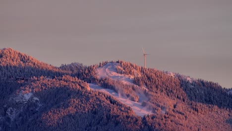 Static-shot-of-Grouse-Mountain-ski-slope-and-Wind-turbine-at-golden-hour