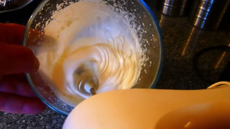 Making-homemade-whipped-cream-stirring-with-kitchen-food-mixer-domestic-life