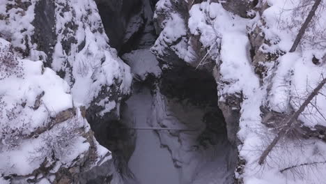 Aerial-flyover-peers-down-into-deep,-narrow-Marble-Canyon-in-winter