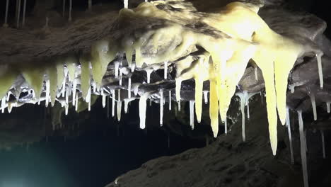 Pale-yellow-calcite-stalactites-on-cave-roof-look-like-melted-cheese