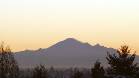 Close-up-static-shot-of-Mount-Baker-during-sunset,-birds-flying