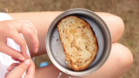 Female-Cleans-Sandwich-From-Foil-I-Container,-Outdoor-Vacation,-Close-Up
