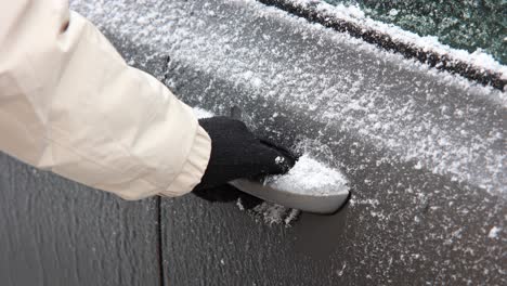 Hand-In-Black-Glove-Trying-To-Open-Frozen-Car-Door-Handle-During-Winter