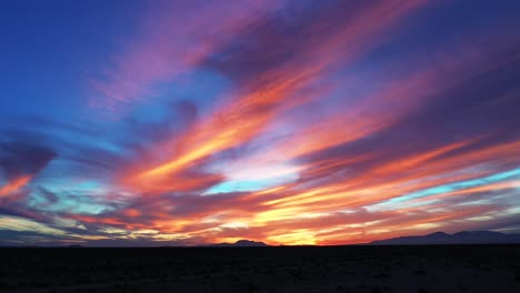 The-Mojave-Desert-during-a-gloriously-colorful-sunset-on-a-romantic-evening---sliding-aerial-view