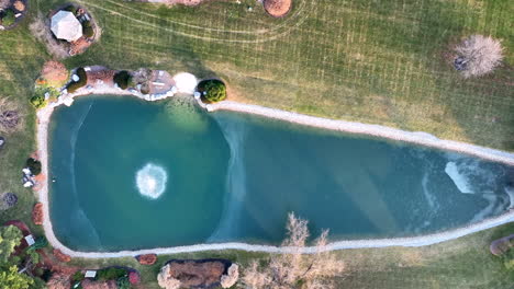 Descending-aerial-on-partially-frozen-water-pond