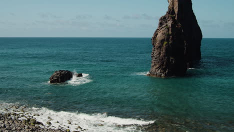 Volcanic-Rock-Formations-Off-The-Shore-With-Waves-Splashing