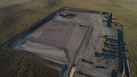 High-altitude-downshot-over-a-mostly-empty-fracking-pad-during-the-late-evening