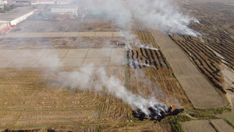 Aerial-TILT-Shot-of-burning-stubble-in-a-vast-open-field