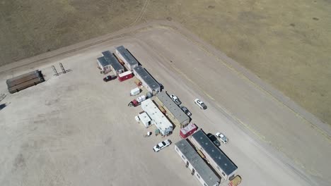 Operations-buildings-on-a-fracking-pad-drone-flight-back-to-reveal-location-on-the-great-plains
