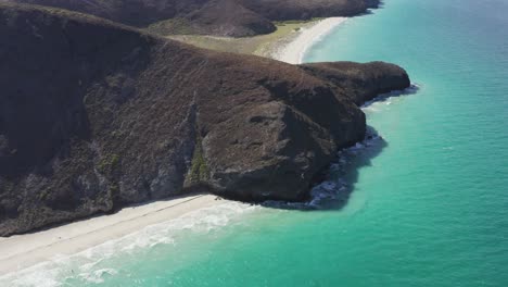 Drone-rotates-over-the-Tecolote-Beach-cliffs-in-Baja,-Mexico