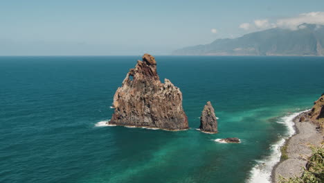 Ilheus-da-Rib-Rock-Formation-By-The-Calm-Blue-Waters-Of-Atlantic-Ocean,-Sea-Stack-At-Ribeira-da-Janela,-Madeira,-Portugal