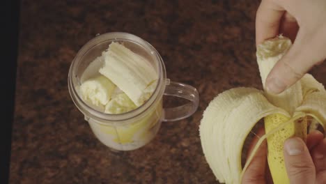 Person-Making-Banana-Smoothie-With-A-Personal-Blender