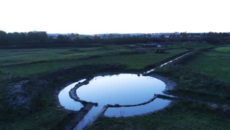Tiny-bird-flying-in-unique-pattern-in-a-mysterious-way-around-circular-water-catchment