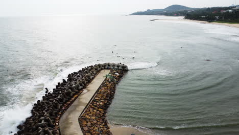 Aerial,-tetrapod-seawall-structures-protecting-coast-from-strong-waves-in-Mui-Ne,-Vietnam