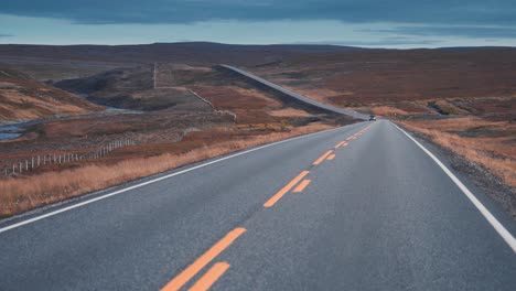 The-two-lane-road-leading-through-the-desolate-autumn-tundra