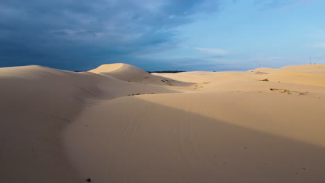 Aerial-forward-view-of-beautiful-white-dunes-losing-themselves-in-the-horizon-at-sunset