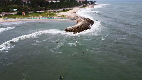 Aerial-circle-view-of-surfers-wait-the-waves