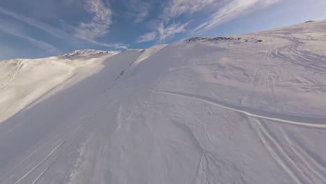 High-speed-race-up-an-empty-ski-pitste-on-beautiful-winter-day,-aerial-fpv-drone
