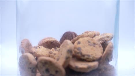 Slow-Motion-shot-of-cookies-falling-into-a-cookie-jar-until-it's-full