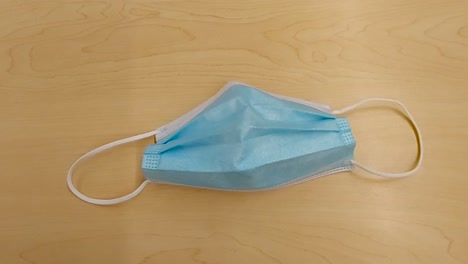 One-light-blue-disposable-medical-mask,-slow-zoom-in