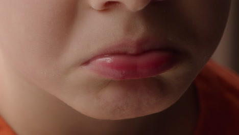Close-up-of-a-little-boy's-pouting-lips-and-mouth