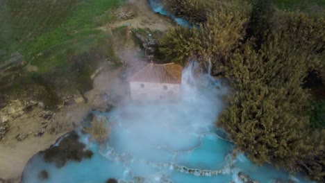 The-thermal-hot-springs-bath-and-waterfall-at-Saturnia,-Tuscany-Italy-close-to-Siena-and-Grosseto-at-sunrise