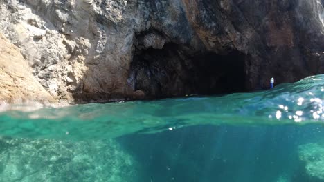 snorkeler-swimming-toward-a-sea-cave