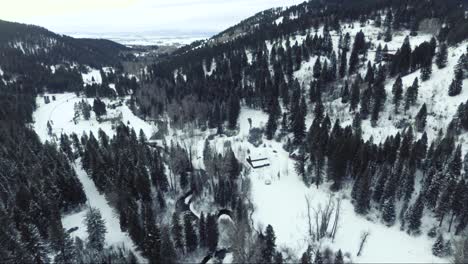 AERIAL---Snowy-covered-canyon-with-winding-river