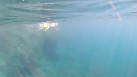 snorkeler-swims-past-a-rocky-shoreline-in-the-British-Virgin-Islands
