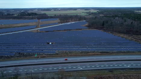 Solar-Park-and-Highway,-Green-infrastructure-in-Northern-Hemusohere,-Aerial-Sideways