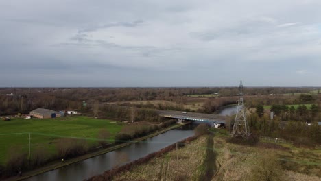 Road-bridge-with-graffiti-over-River-Cam-Cambridgeshire-UK-aerial-drone-footage