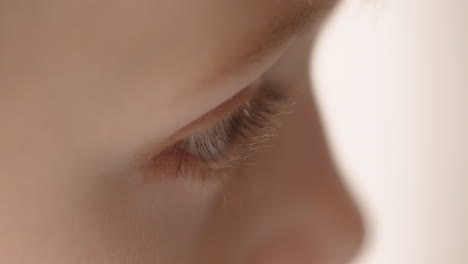Extreme-close-up-side-view-of-a-child's-eye-watching-something
