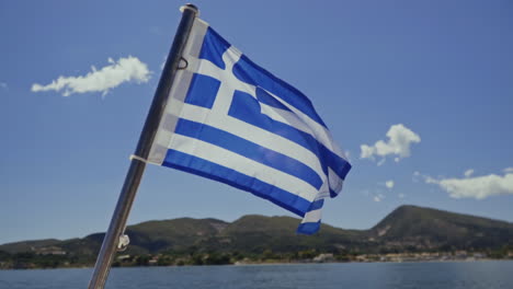 Greek-national-flag-flying-in-breeze-in-Mediterranean-islands,-slow-motion
